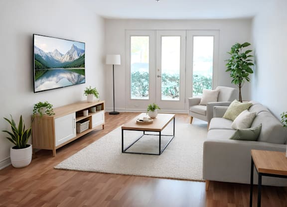 A modern living room with a large painting on the wall and a view of the outdoors through the sliding glass doors.