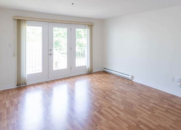 A room with a sliding door and a wooden floor.