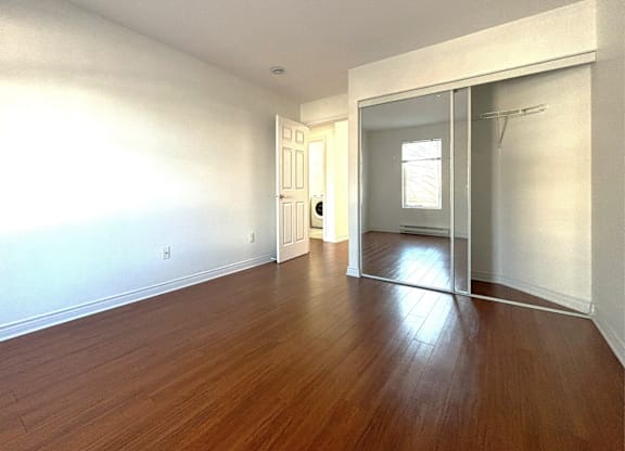 A room with wooden floors and white walls.