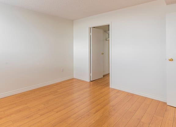 A room with wooden floors and a white door.