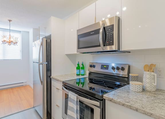 A modern kitchen with a stove, oven, and microwave.