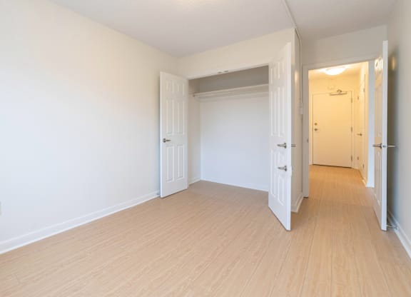 A room with a white door and a white wall.