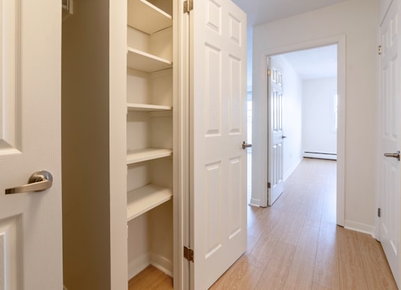 A white door is open to a hallway.
