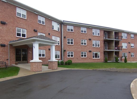 A large brick building with a covered walkway in front.