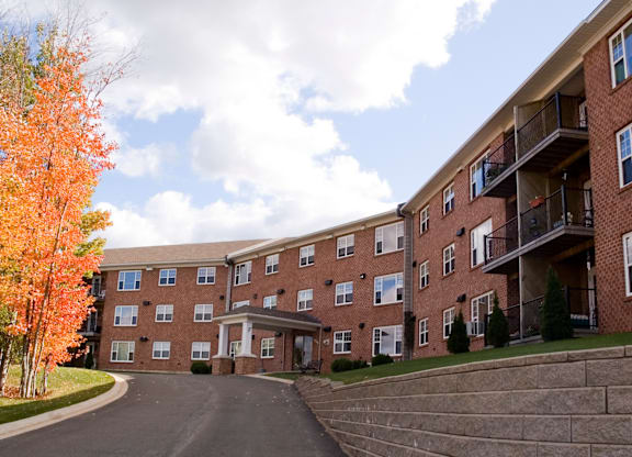 A large apartment complex with a driveway in front.
