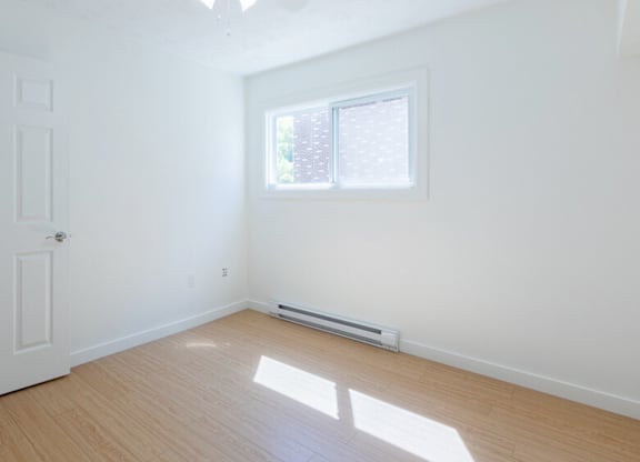 A room with a ceiling fan and a window.