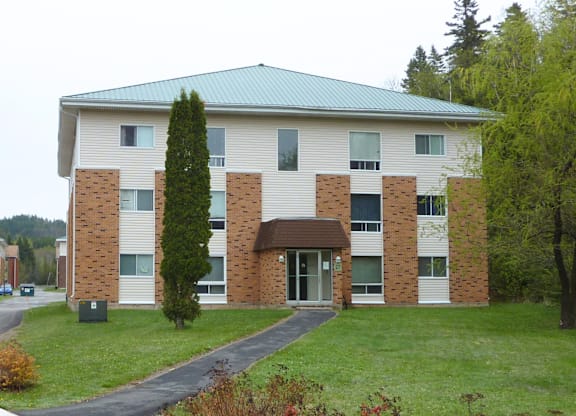 A large building with a green roof and a brick facade.