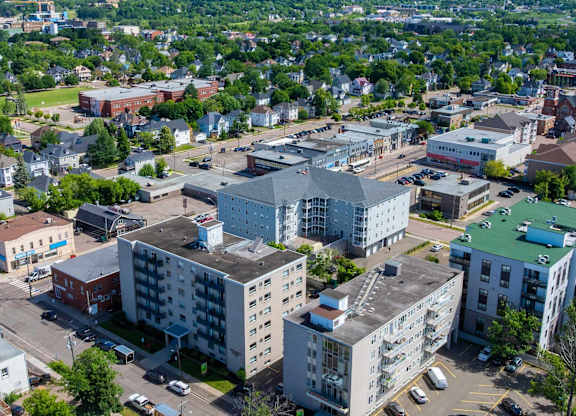 A parking lot with cars and a building in the background.