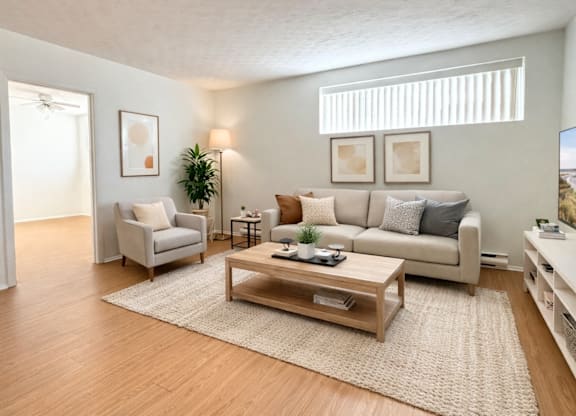 A living room with a couch, chair, and coffee table.