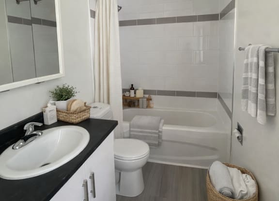 A bathroom with a sink, toilet, and bathtub.