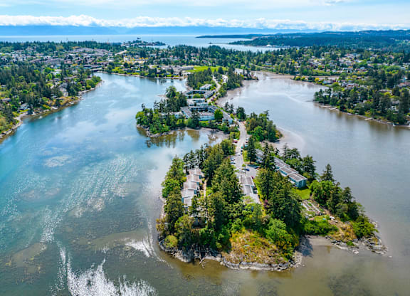 A small island with a building surrounded by water.