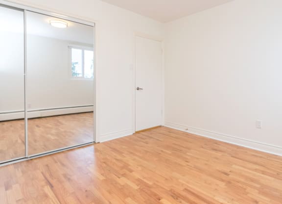 A room with a white door and a sliding glass door.