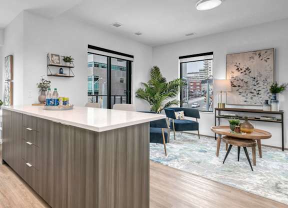 A modern kitchen with a white countertop and wooden cabinets.