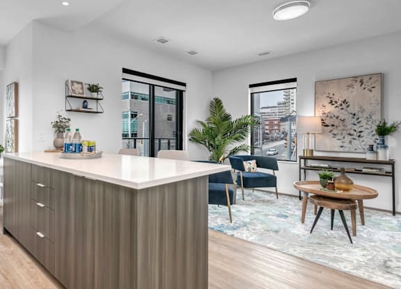 A modern kitchen with a white countertop and wooden cabinets.