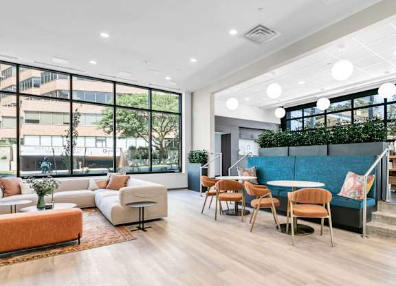 A modern living room with a large window and a view of the city.