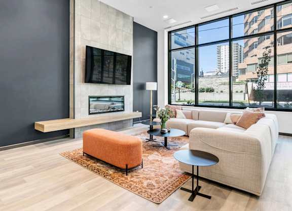 A modern living room with a large window overlooking the city.