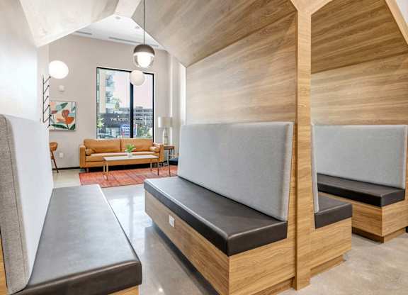 A room with a couch and two benches with wooden walls.