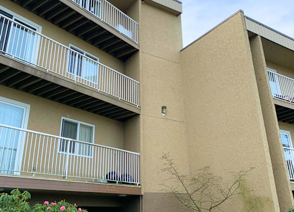 A building with beige walls and white railings.