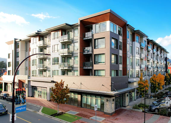 A modern apartment building with a street in front.