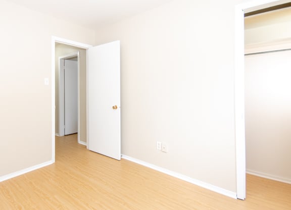 A room with a white door and a white wall.
