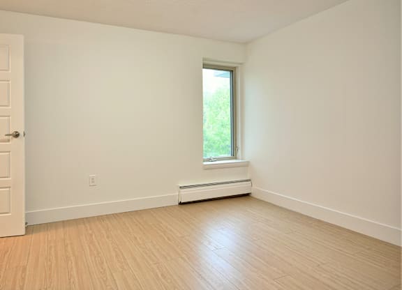 A room with a window and a door.