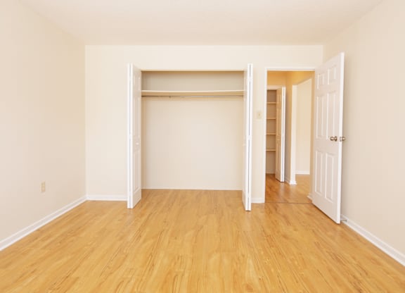 A room with a white door and a white wall.