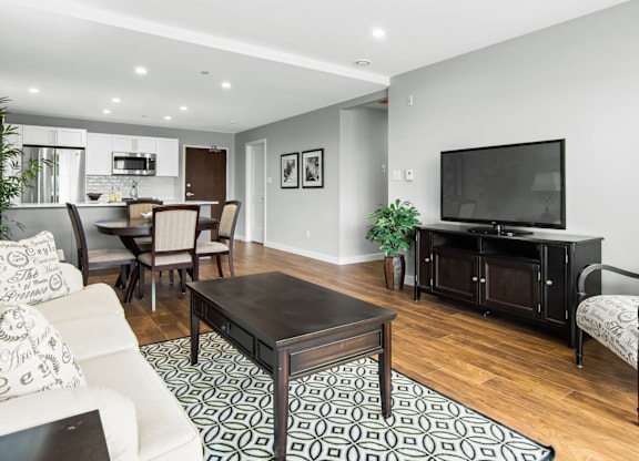 A modern living room with a black coffee table and a white sofa.