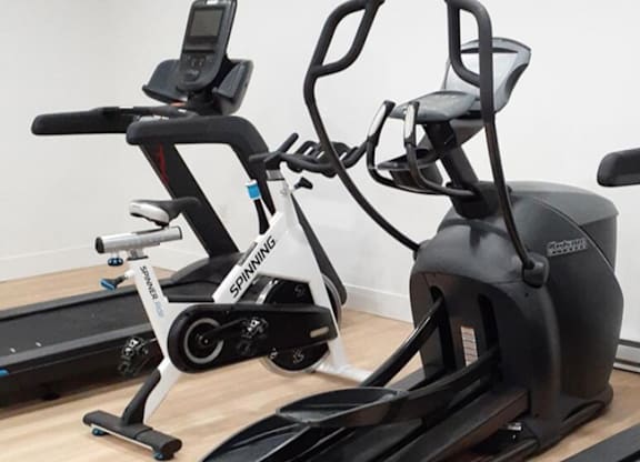 A Spinning bike is on the left and a recumbent bike is on the right.