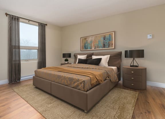 A bedroom with a large bed, nightstand, and a painting on the wall.