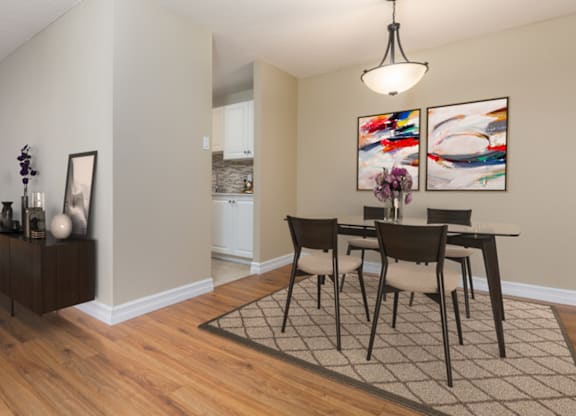 A dining room with a table set for four.