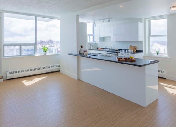 A spacious kitchen with a large island and wooden flooring.