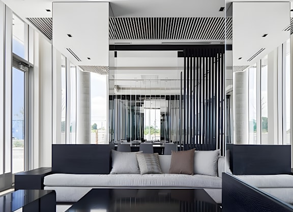 A modern living room with a black and white color scheme.