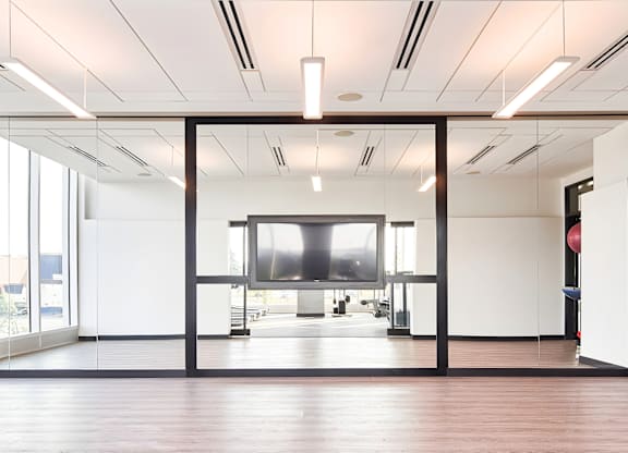 A modern office space with a large screen in the center.