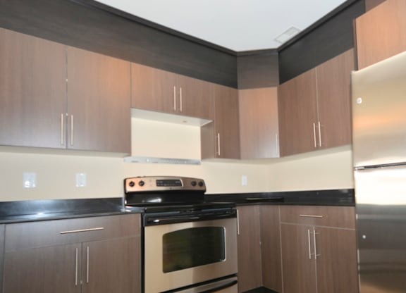 A kitchen with a stove and cabinets.