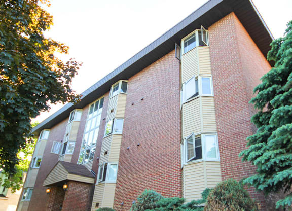 A red brick building with a balcony on the second floor.