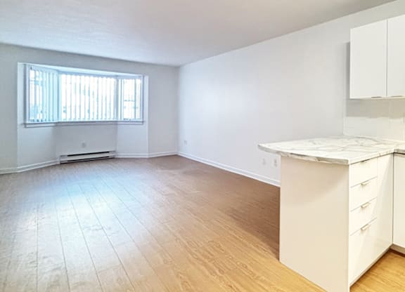 A room with a window and a counter.