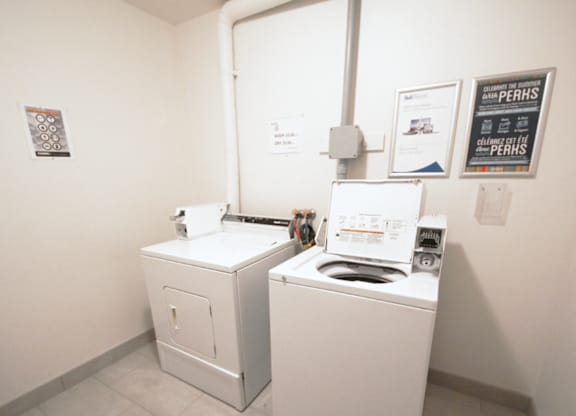 A washing machine and dryer in a small room.
