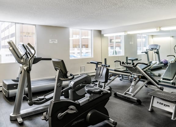 A gym with treadmills, elliptical machines, and other exercise equipment.
