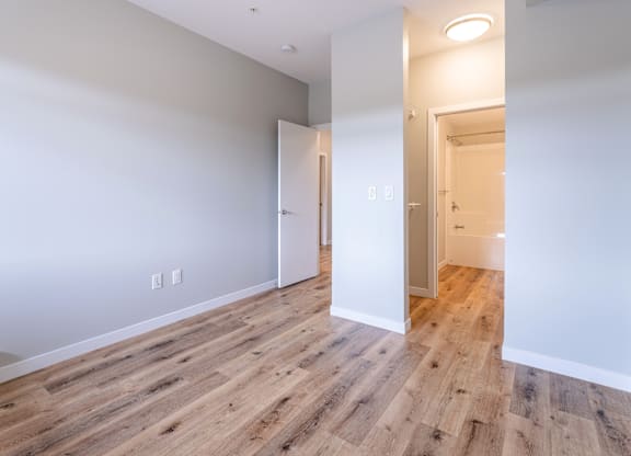 A room with a wooden floor and white walls.