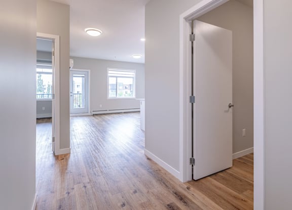 A room with a white door and a window.