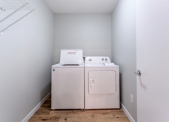 A white washer and dryer in a small laundry room.
