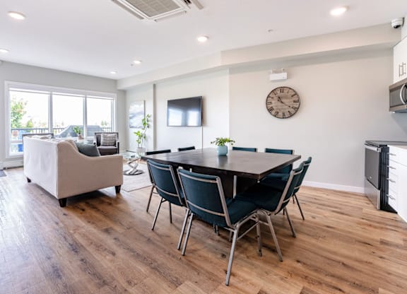 A modern dining room with a wooden table and chairs.