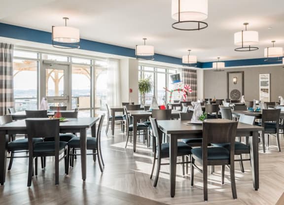 A modern dining room with a large table and chairs.