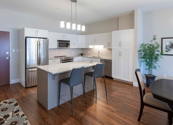 A kitchen with a white countertop and a refrigerator.