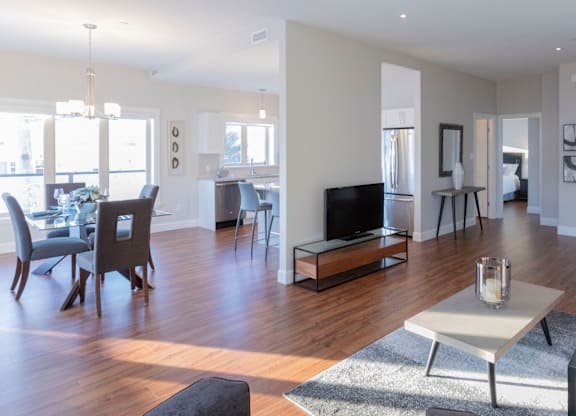 A modern living room with a fireplace and a dining area.