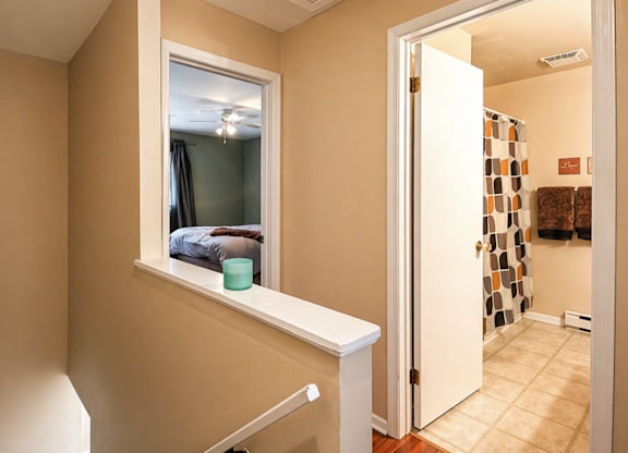 A room with a window and a door leading to another room.