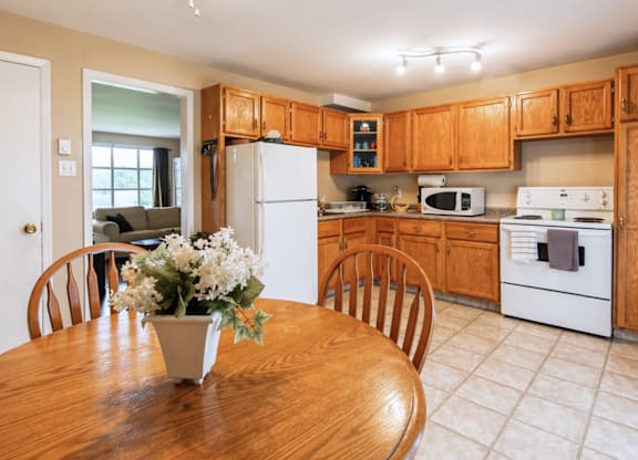 A kitchen with wooden cabinets and white appliances.