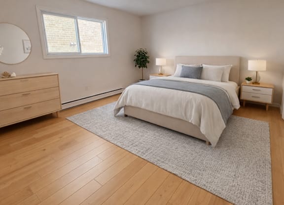 A bedroom with a large bed, a dresser, and a window.