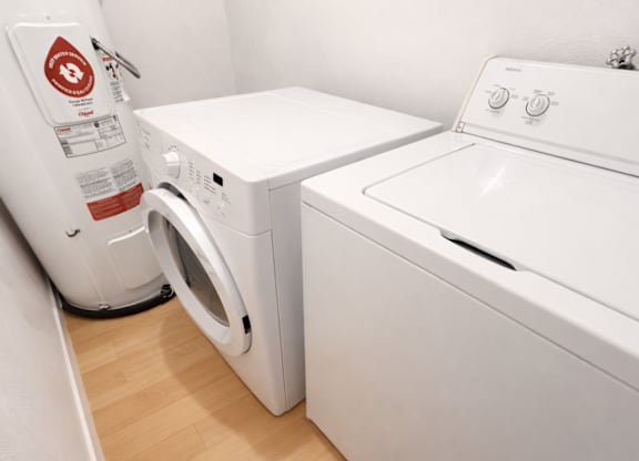 A white washing machine and dryer in a small laundry room.