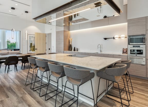 A modern kitchen with a large island and bar stools.